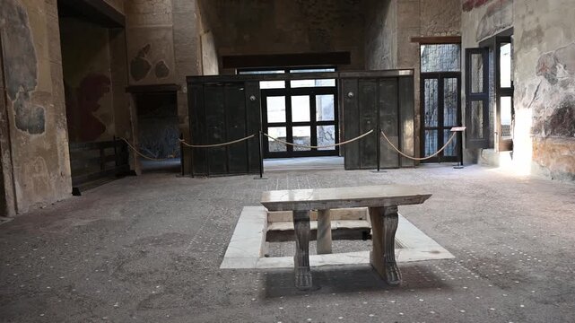 ERCOLANO, ITALY - SEPTEMBER 20, 2026: Ancient Roman atrium with carbonized wooden partition screen inside the House of the Wooden Partition in Herculaneum archaeological site.