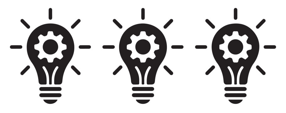 Industrial brainwork icons with glowing rays and gear wheel inside lightbulbs showing productive creation.