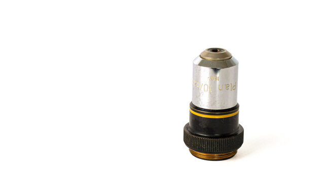 Plan 10x microscope objective marked 10/0.20 and 160/- with a silver and black metal housing and yellow identification ring, isolated on a white background.