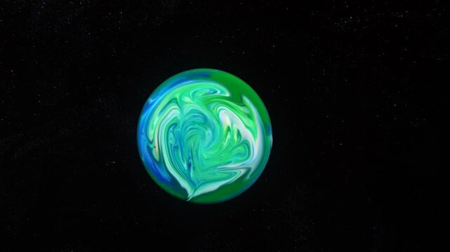 Against a black background, a spherical object is depicted with an abstract pattern of blue, green, and white hues. Visually, it resembles a planet or a cosmic body in space.