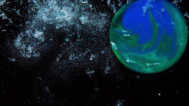 An abstract green planet in a starry galaxy.