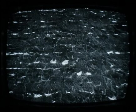 Vintage television screens displaying static with subtle graphical glitches during a cinematic broadcast interruption