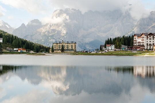 Lago di Misurina showcases breathtaking reflections of the towering Dolomites in Italy. This picturesque destination invites visitors to enjoy serene landscapes, perfect for a memorable vacation.