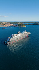 Vertical aerial view of luxury cruise ship cruising off Rovinj old town peninsula in Istria Croatia © POV_artist