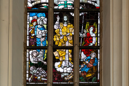 Close-up on religious stained-glass decoration showing Jesus preaching among saints