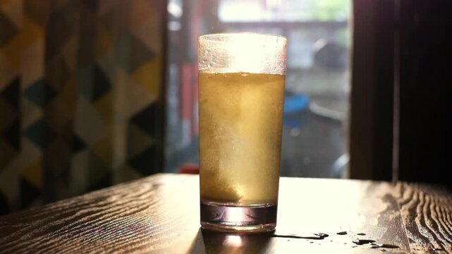 Effervescent tablet vitamin C nutritional supplements in glass with yellow carbonated water, sport medication, healthy morning. Aspirin antipyretic drugs