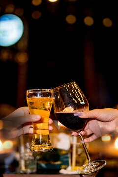 food and drink male friends are happy drinking beer and clinking glasses at a bar or pub.