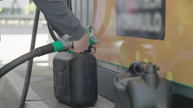 Filling-up the fuel container at gas station close-up