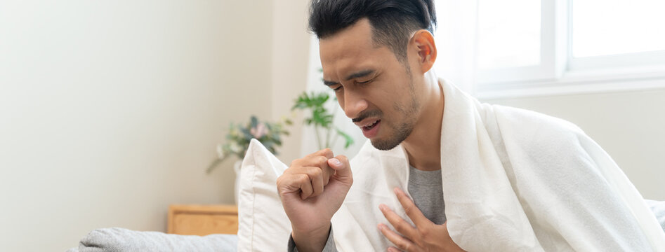 Close-up young men seriously coughing and has chest pain from lung cancer.