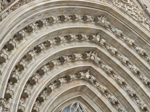 Close-up of concentric decorative stone arches of a historic gothic building entrance