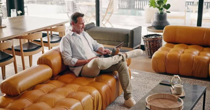 Man, excited or laptop on sofa for remote work, crypto trading or stock market feedback in home. Mature trader, fist pump or tech in living room for online achievement, financial gains or investment
