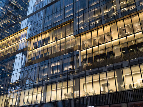 Low-angle view of a business office building at Hudson Yards in Midtown Manhattan at dusk.