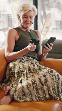 Phone, celebration or woman with credit card in home, comedy subscription or payment success. Mobile, mature person or debit on sofa for membership fee to funny service, fist pump or yes for discount