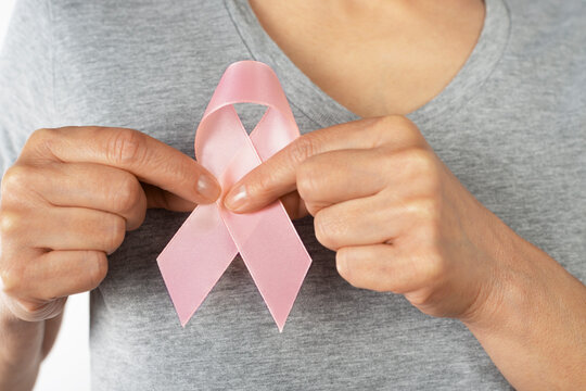 Breast Cancer Awareness Ribbon Held by Woman