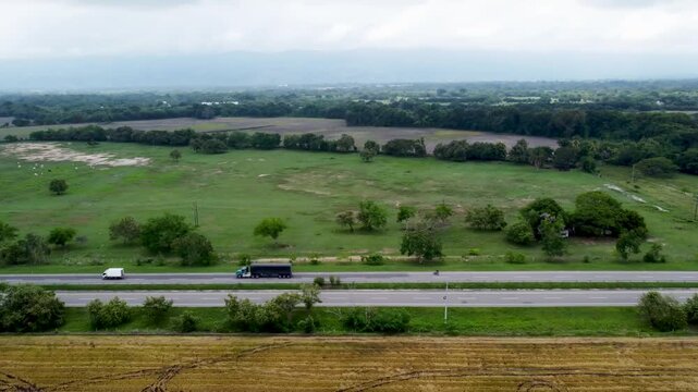 Aerial view drone of empty road clouddy day grass and forest area, Tolima, Colombia 4k