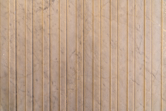Marble panel with vertical grooves on interior wall surface