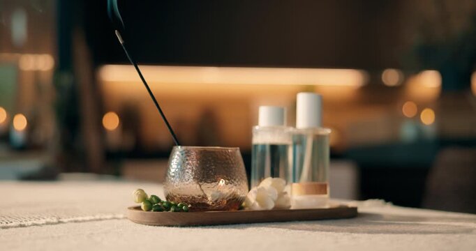 Incense, flower and smoke at spa for aroma, ambience and essential oil for aromatherapy session. Empty, salon and stick at luxury resort with cosmetics, fragrance mist and scent therapy for wellness