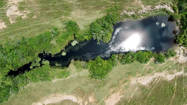 Top view drone of grass and forest area, lake, river clouddy day , Tolima, Colombia 4k