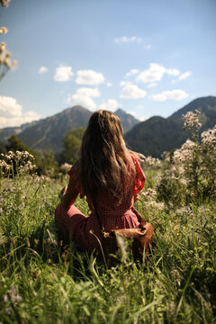 woman sitting on a mountain top