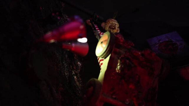 Halloween horror attraction features a grotesque butcher figure surrounded by bloody props and dark shadows creating a disturbing scene inspired by classic haunted nightmares