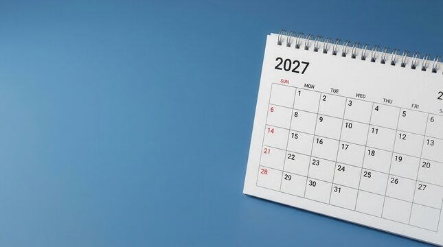 Close up of a desk calendar for the year 2027 on a blue background with copy space for planning.