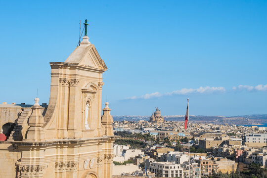 Facade of Cathedral of the Assumption with a niche with Virgin Mary, island architecture with the Rotunda of Xewkija on the horizon, Victoria - Gozo MALTA