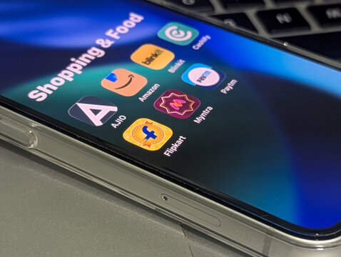 Online shopping and food delivery apps folder on smartphone display close up stock photo