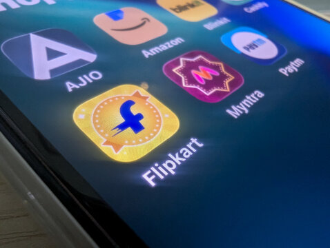 Flipkart app icon on smartphone screen alongside ecommerce shopping apps close up stock photo
