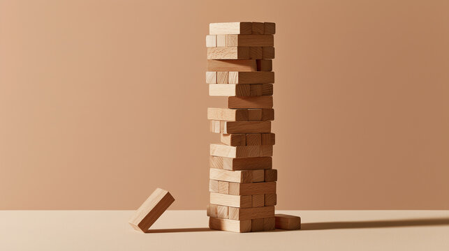 Wooden block tower with one block pulled out on a pastel surface, risk concept