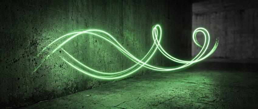Neon green light painting spirals across gritty concrete corner, long exposure captures fluid wave, loops and cursive flourishes in dark industrial space