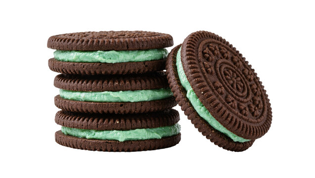 Stack of dark chocolate sandwich cookies with mint cream filling, isolated on transparent background