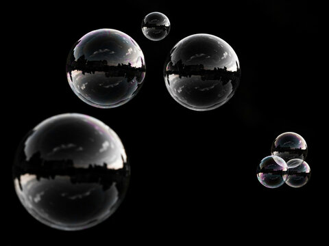 Abstract glass bubbles floating in dark space with reflections and copy space