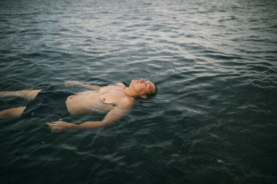 Man lying on he back in the sea