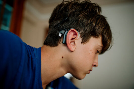 Teen Student with Cochlear Implant Focused on Schoolwork