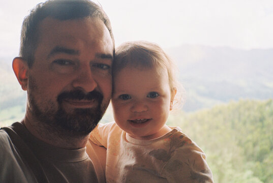 Selfie of a father and baby opposite the mountains