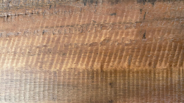 Brown rough sawn wooden board texture with saw marks