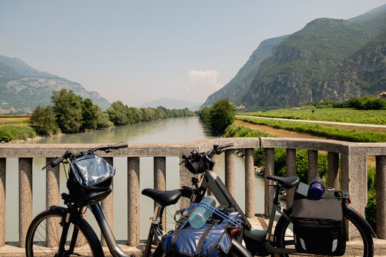 Touring bikes overlooking Adige River and alpine valley
