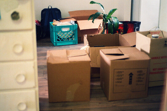 Boxes randomly disposed in a flat during a moving day