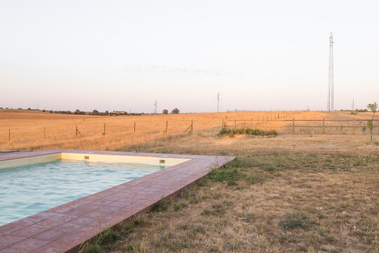 Swimming pool at country house surrounded by rural landscape
