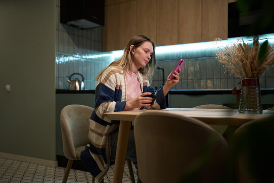 Woman relaxing with coffee and smartphone practicing digital balance