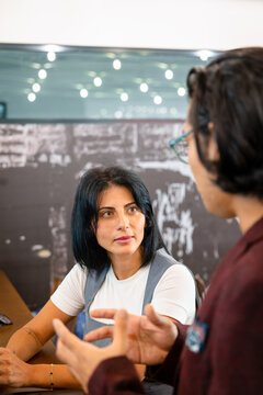 Young woman talking to a male colleague in the office