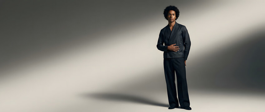 Black man, fashion and portrait with suit in studio for clothing brand, advertising and marketing campaign. Male model, luxury and outfit with designer style, elegant apparel and minimalist look