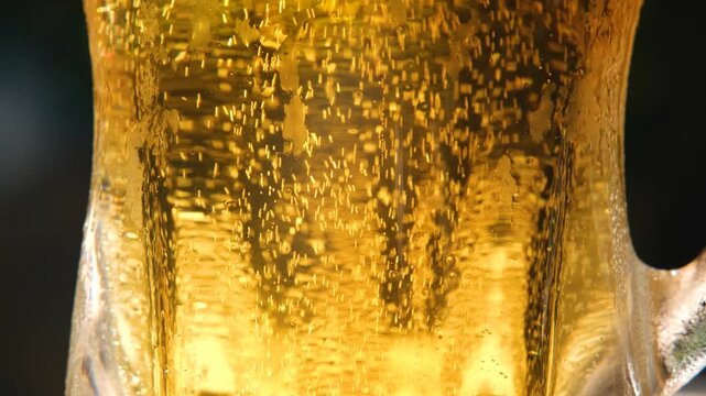Closeup of Effervescent Bubbles in Fresh Beer. Beer Bubbles Rising from the Bottom of a Glass. Fizzy Beer Bubbles Moving Toward the Surface.