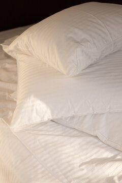 Stack of Fluffy White Pillows with Soft Morning Sunlight