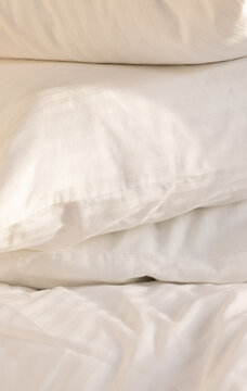 Stack of Fluffy White Pillows with Soft Morning Sunlight