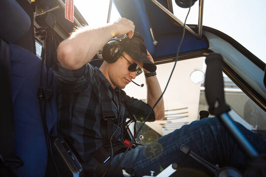 Private Helicopter Pilot Preparing for Flight in Cockpit