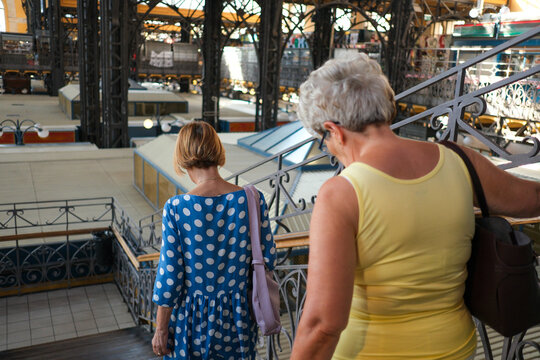 Women Descending Stairs in Budapest Market Hall