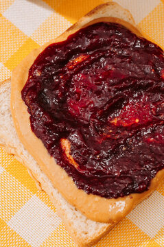 Plum jam and peanut butter on bread slice