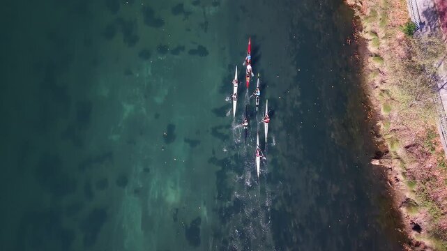 Group of canoeists paddling on the river during training