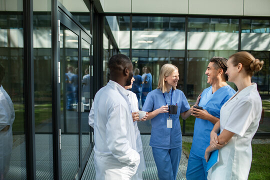 Healthcare team chatting during coffee break outside hospital